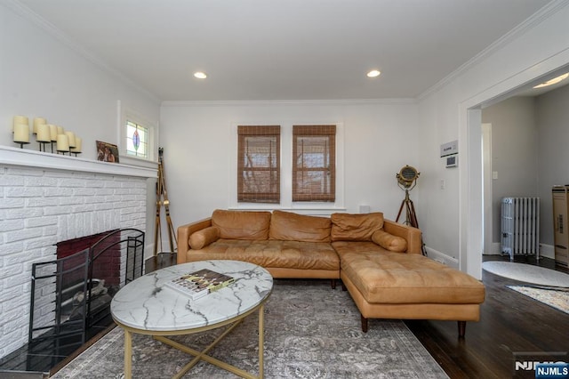 living area featuring recessed lighting, radiator, ornamental molding, and wood finished floors