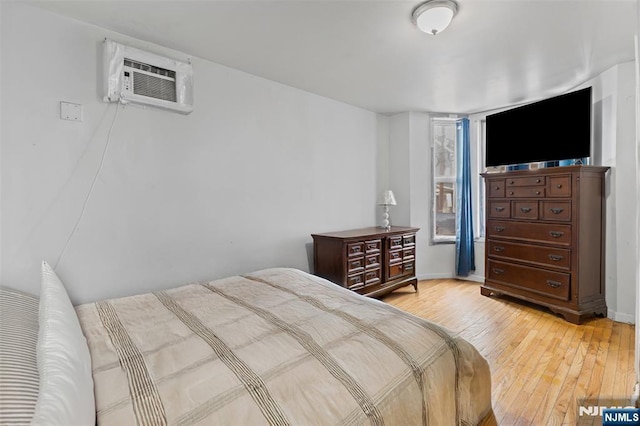 23 Foundry St, Newark, NJ 07105 - bedroom with baseboards, light wood-style flooring, and a wall unit AC