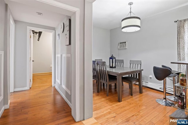 23 Foundry St, Newark, NJ 07105 - dining room featuring visible vents, light wood-style flooring, baseboards, and a wall unit AC