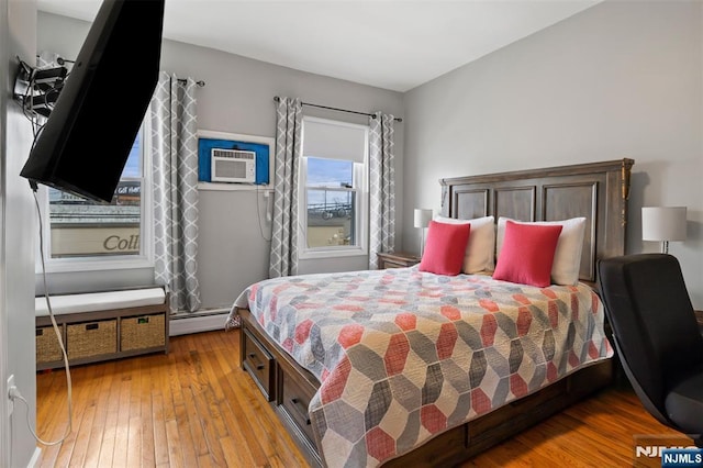 23 Foundry St, Newark, NJ 07105 - bedroom featuring a wall mounted AC, light wood-type flooring, and baseboard heating