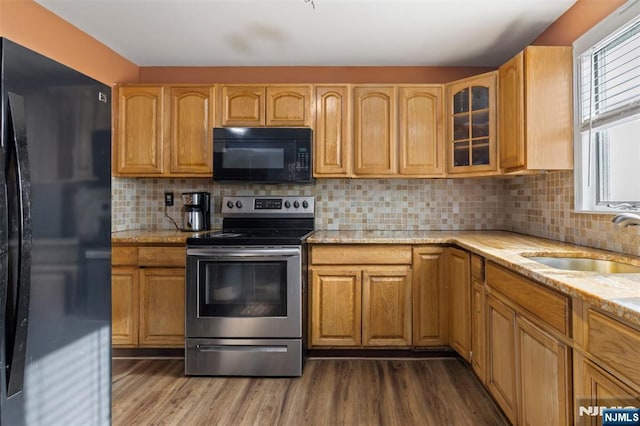 23 Foundry St, Newark, NJ 07105 - kitchen featuring black appliances, light stone countertops, a sink, and dark wood-type flooring