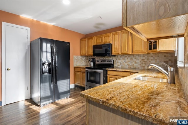 23 Foundry St, Newark, NJ 07105 - kitchen featuring wood finished floors, a sink, black appliances, glass insert cabinets, and backsplash