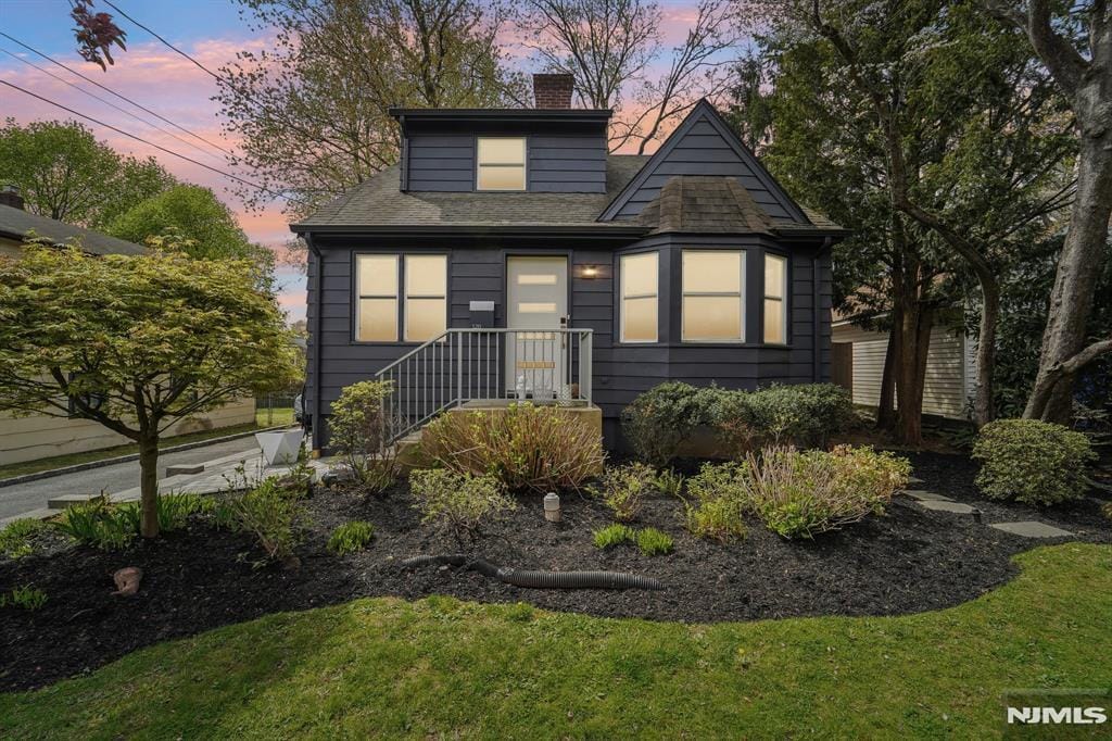 120 Gordon Ave, Tenafly, NJ 07670 - bungalow-style home featuring a lawn, a chimney, and roof with shingles