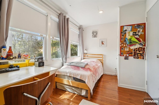 bedroom featuring baseboards and wood finished floors