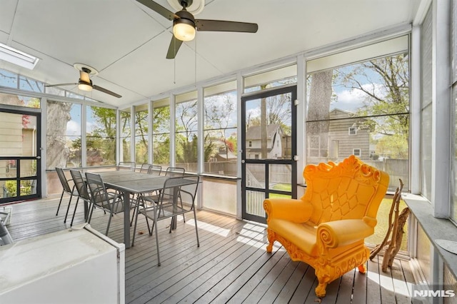 sunroom / solarium featuring a ceiling fan and outdoor dining space