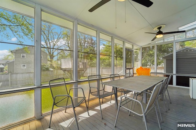 sunroom featuring outdoor dining area and ceiling fan