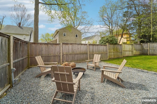 exterior space featuring a fenced backyard and an outdoor fire pit