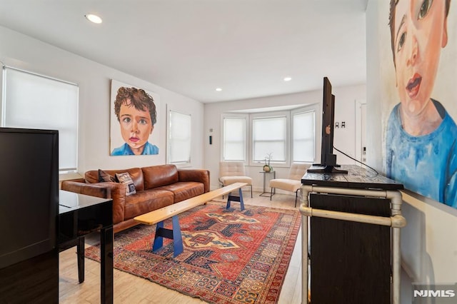 living area with recessed lighting and wood finished floors