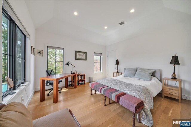 bedroom featuring lofted ceiling, visible vents, recessed lighting, and light wood-style flooring
