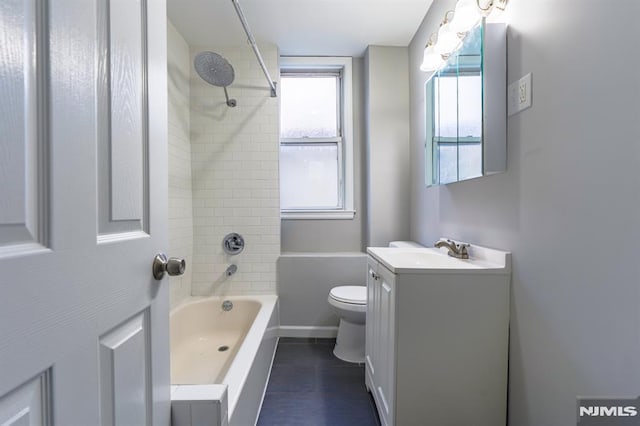 bathroom featuring baseboards, shower / bathtub combination, toilet, and vanity