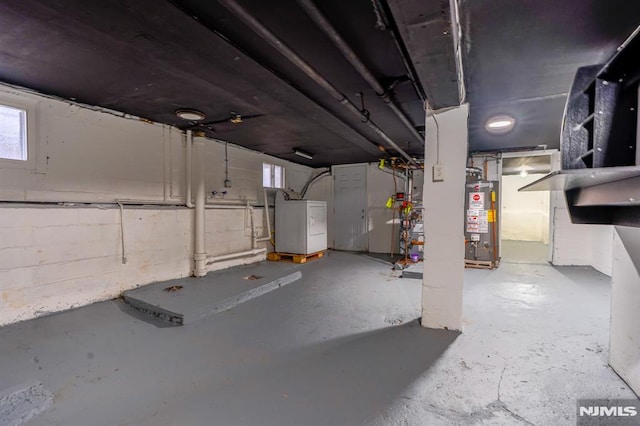 below grade area featuring washer / dryer and gas water heater