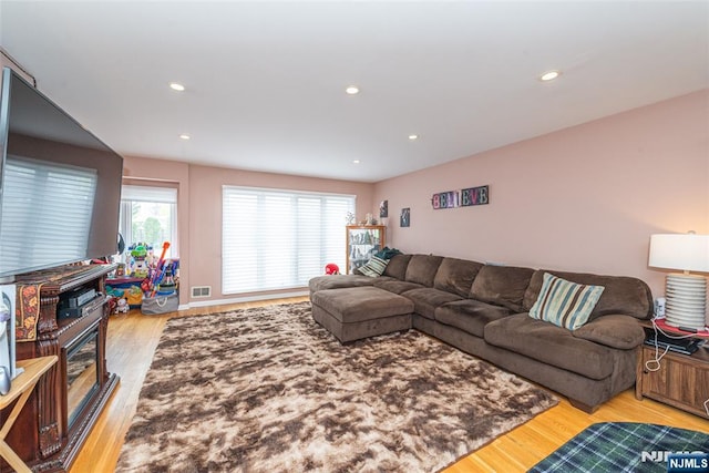 living area featuring recessed lighting, wood finished floors, and visible vents