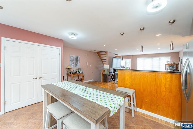 dining space with light tile patterned floors, a dry bar, and recessed lighting