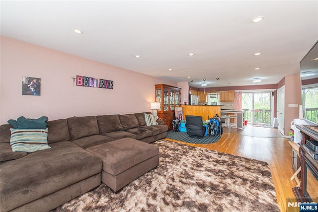 living area featuring light wood finished floors and recessed lighting