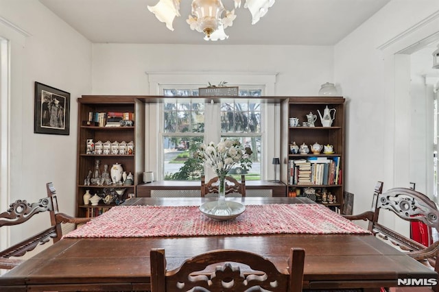 dining area with an inviting chandelier