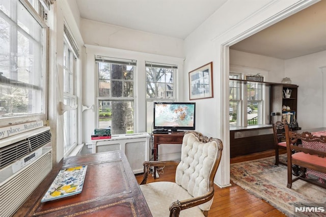 home office featuring cooling unit and hardwood / wood-style flooring