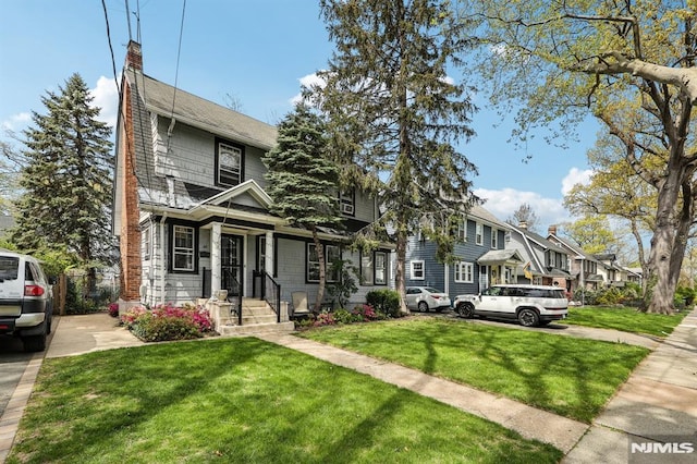 view of front of home featuring a residential view and a front lawn