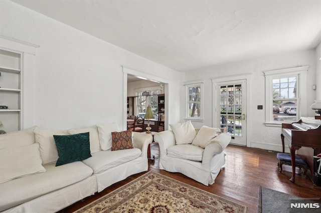 living room with baseboards and wood finished floors