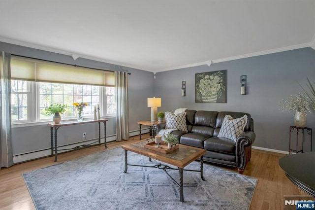 living area with a baseboard heating unit, baseboards, baseboard heating, wood finished floors, and ornamental molding