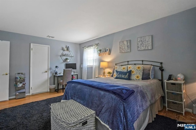 bedroom with wood finished floors and visible vents