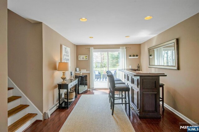 interior space with baseboards, dark wood-style floors, and recessed lighting