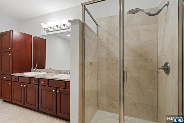 full bathroom with a stall shower and double vanity