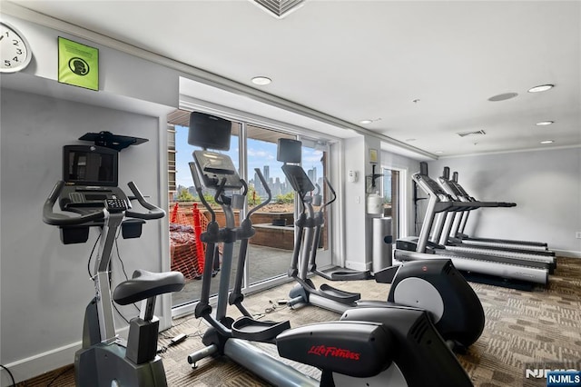 workout area featuring baseboards, recessed lighting, and ornamental molding