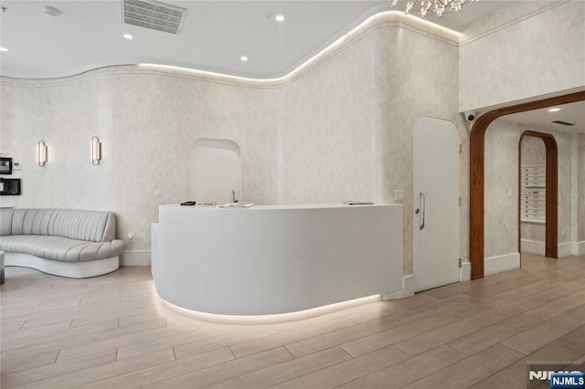 reception area featuring a towering ceiling