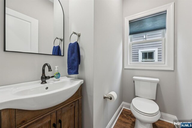 5 Banks Dr, Boonton Town, NJ 07005 - half bath with wood finished floors, baseboards, vanity, and toilet