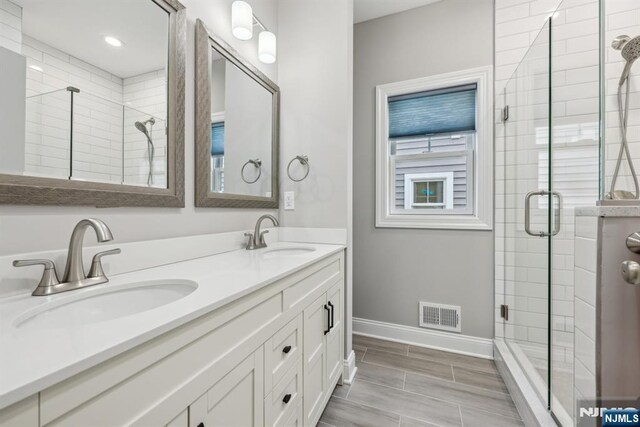 5 Banks Dr, Boonton Town, NJ 07005 - bathroom featuring baseboards, a sink, visible vents, and a stall shower