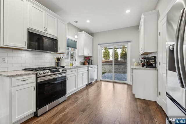 5 Banks Dr, Boonton Town, NJ 07005 - kitchen featuring white cabinets, stainless steel appliances, dark wood-style floors, a sink, and decorative backsplash