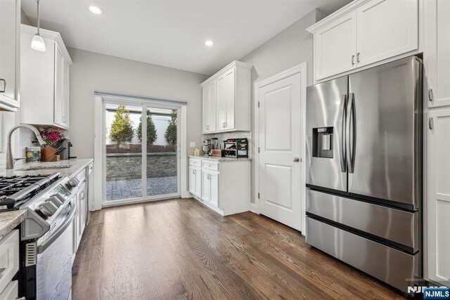5 Banks Dr, Boonton Town, NJ 07005 - kitchen featuring white cabinets, dark wood finished floors, stainless steel appliances, a sink, and light stone countertops