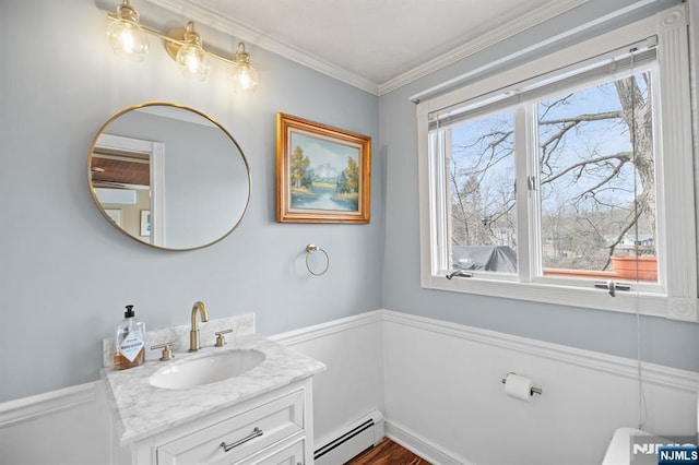 bathroom featuring wainscoting, vanity, a baseboard radiator, and crown molding