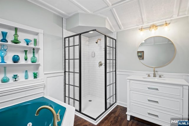 full bath with wood finished floors, a tub with jets, vanity, and a stall shower