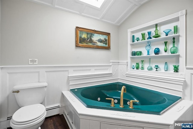 full bathroom featuring wood finished floors, baseboard heating, a jetted tub, and toilet
