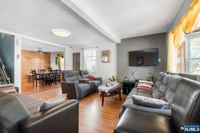 living room featuring a ceiling fan and wood finished floors
