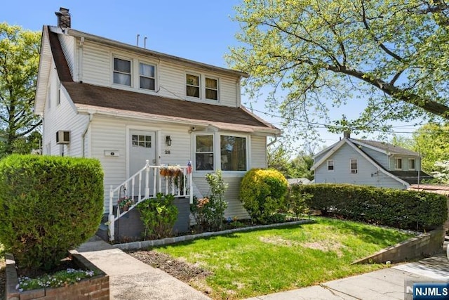 view of front of house with a chimney and a front yard