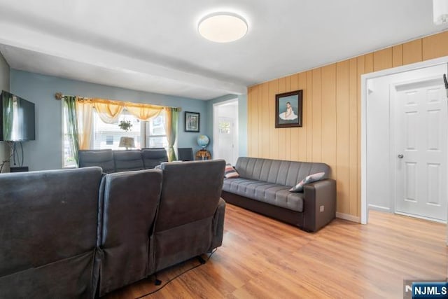 living room with baseboards and wood finished floors