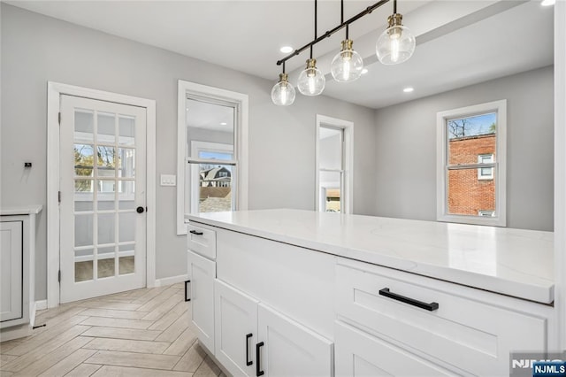 interior space with plenty of natural light, baseboards, and recessed lighting