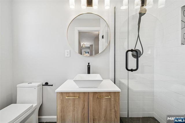 full bath featuring toilet, vanity, and a stall shower