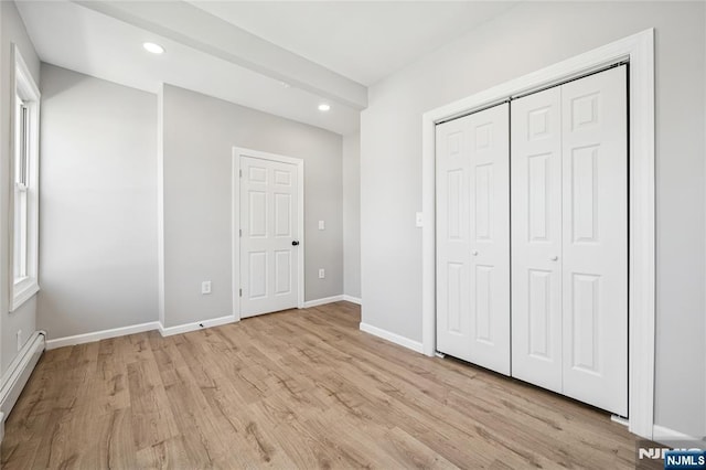 unfurnished bedroom featuring baseboards, light wood-style flooring, baseboard heating, and recessed lighting