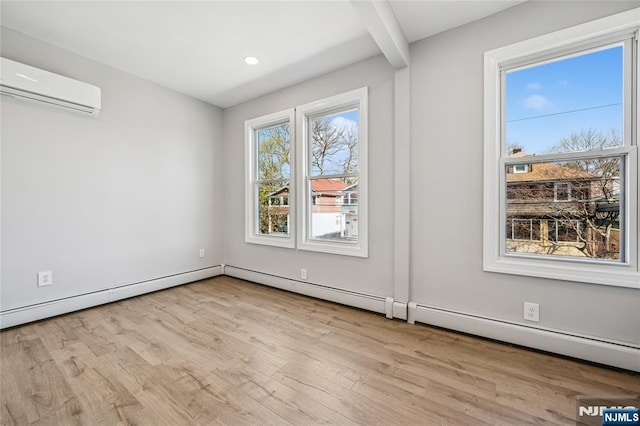 spare room featuring wood finished floors, recessed lighting, and a wall mounted air conditioner