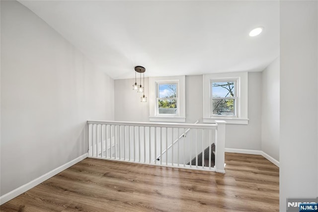 bonus room with wood finished floors and baseboards