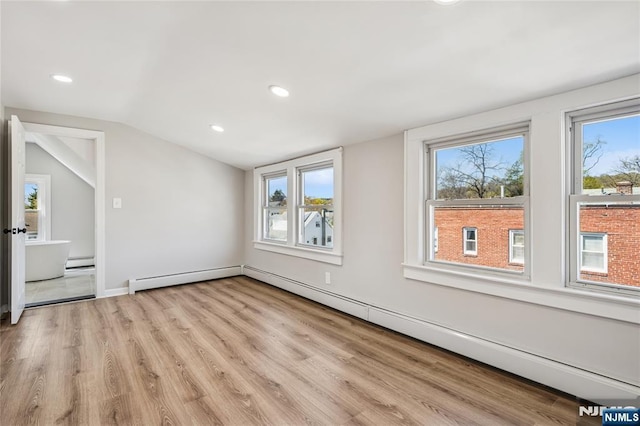 bonus room featuring a baseboard heating unit, vaulted ceiling, light wood-style flooring, and recessed lighting