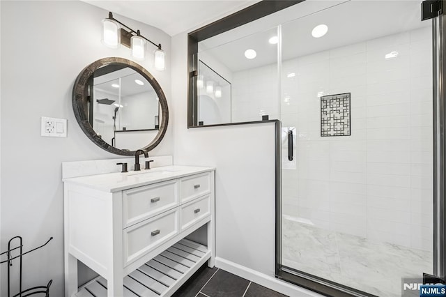 bathroom with a shower stall, vanity, tile patterned flooring, and recessed lighting