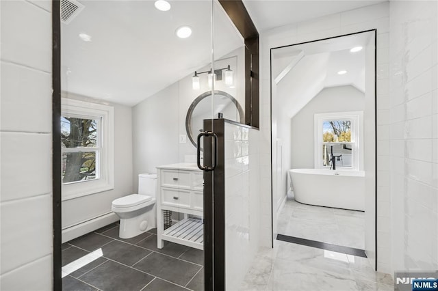 bathroom with a healthy amount of sunlight, recessed lighting, a baseboard radiator, and a freestanding bath