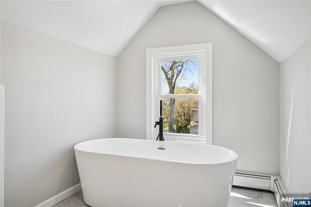 full bath featuring vaulted ceiling, baseboards, and a freestanding bath