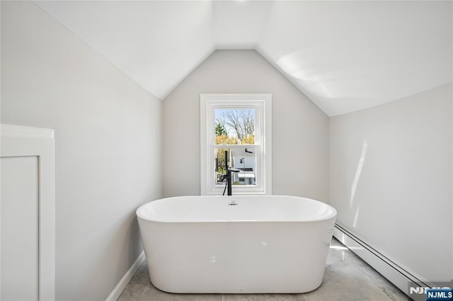 full bathroom featuring lofted ceiling, a freestanding tub, and baseboard heating