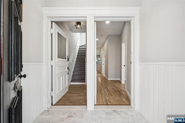 interior space with wainscoting and stairway