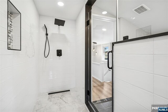 bathroom with a shower stall, visible vents, and recessed lighting